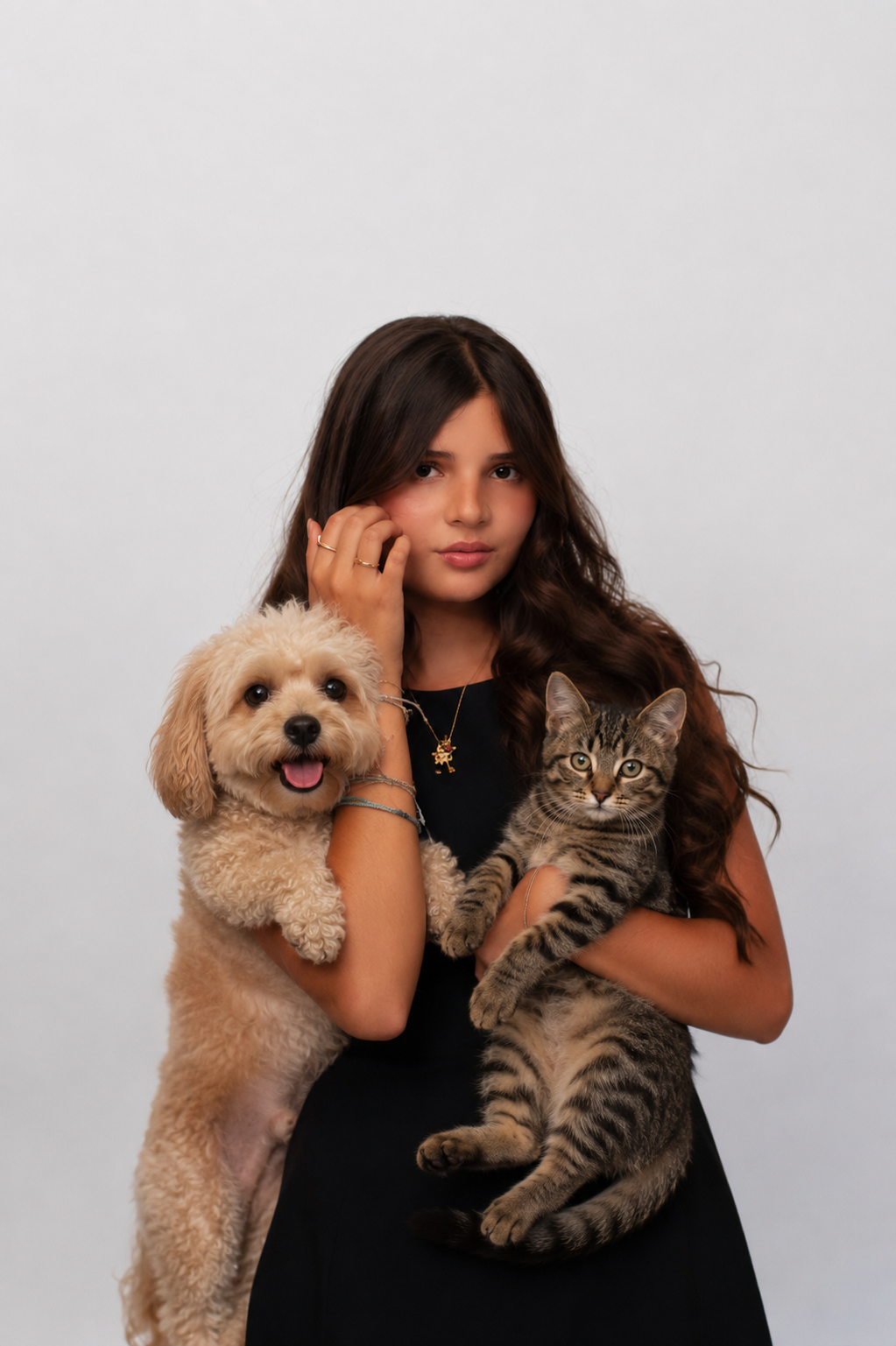 Mar Diaz, founder of BuddyUp Care, holding a rescue dog and a rescue cat